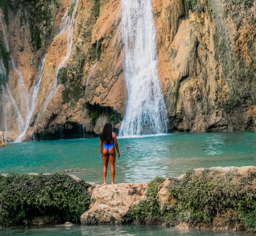 A girl standing in front of Cascada de Aguacate, one of the best waterfalls in Mexico