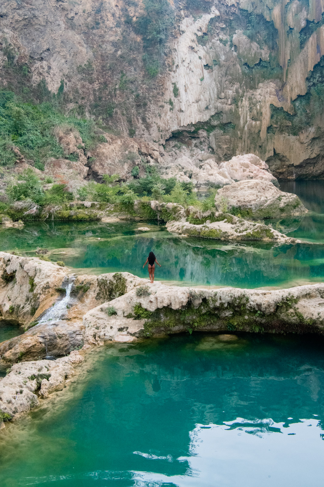 A girl standing in front of Cascada el Salto waterfall, one of the best waterfalls in Mexico. 
