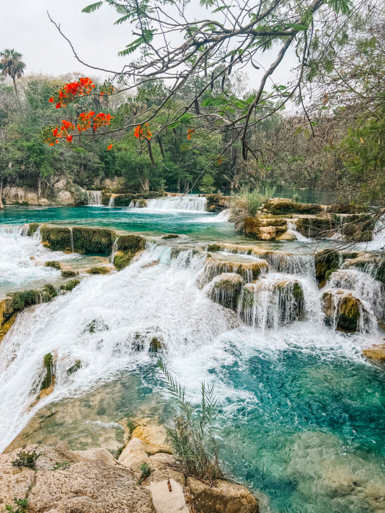 A photo of cascada el meco cascading down into multiple pools, one of the best waterfalls in Mexico.