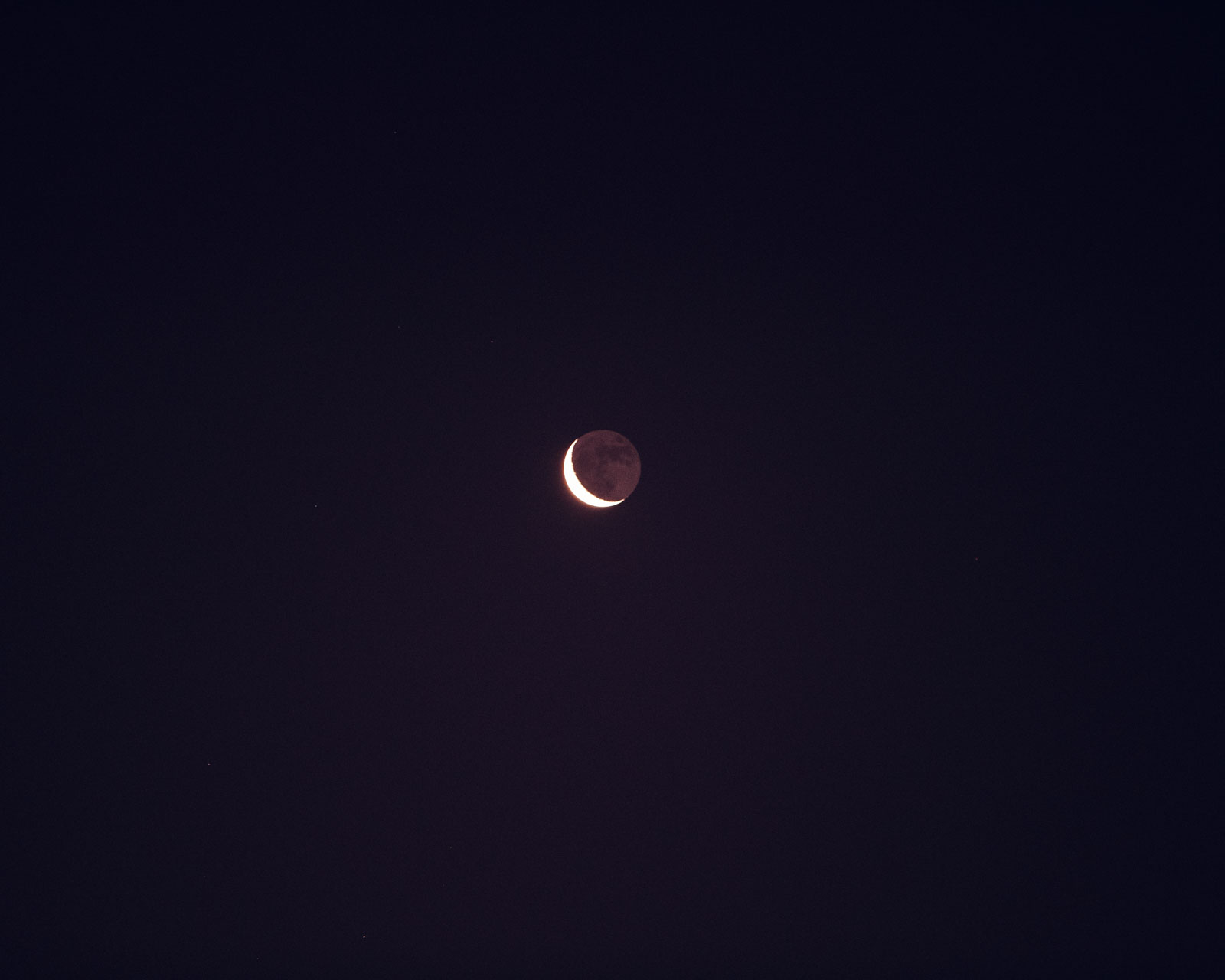 The moon setting in Lake Atitlan