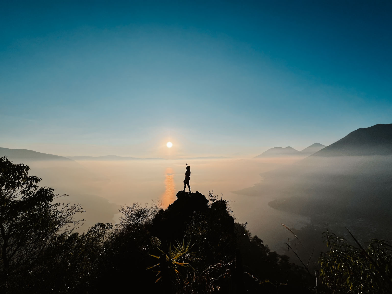 Woman standing on top of Indian Nose in Lake Atitlan